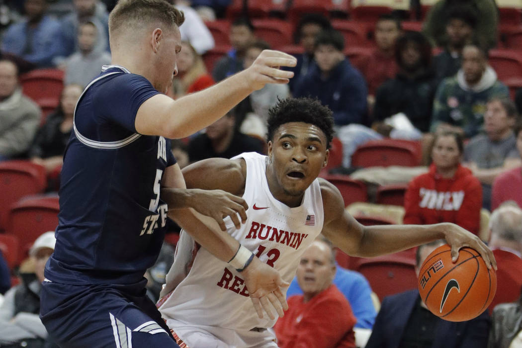 UNLV's Bryce Hamilton (13) drives around Utah State's Sam Merrill during the second half of an ...