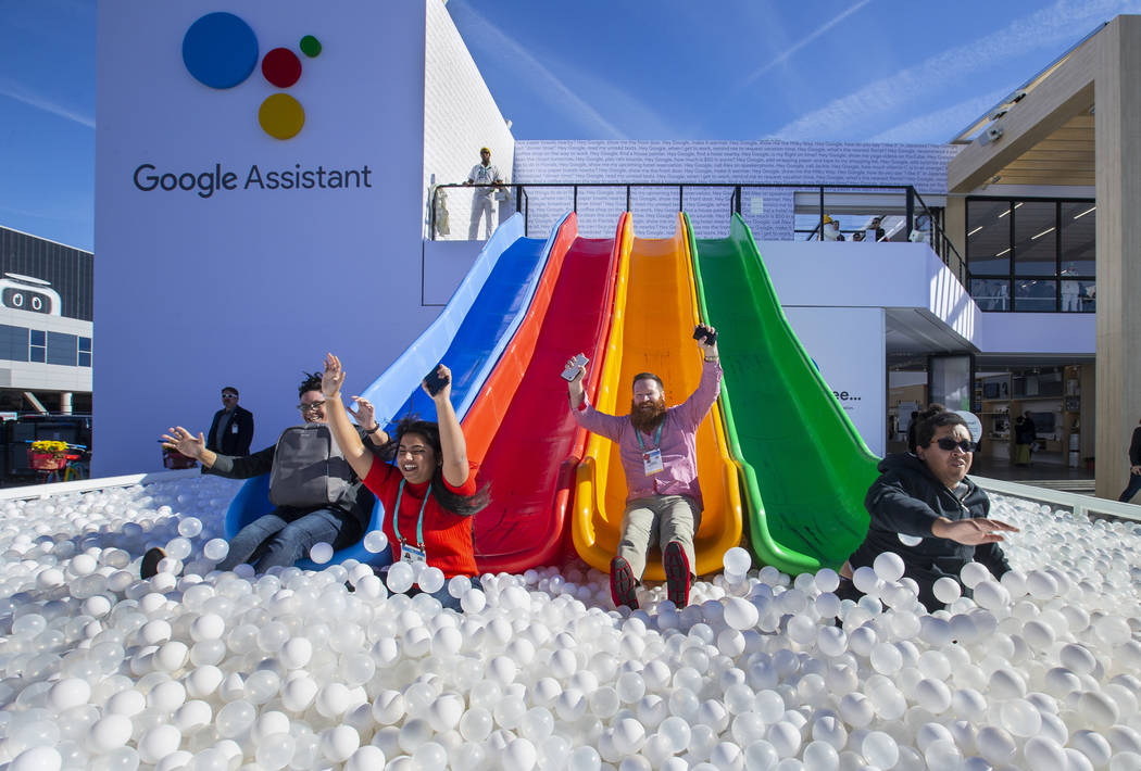 Robert McKenna, center, joins others down into a ball pit outside the Google display center on ...