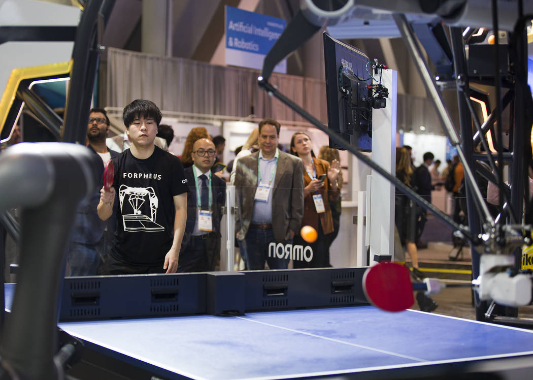 Yuki Sasayi plays ping pong with Forpheus, an AI equipped robotic table tennis tutor created by ...