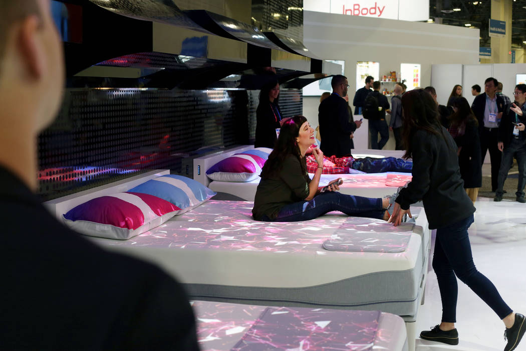 CBS Interactive's Megan Wollerton sits on a CLIMATE360 Smart Bed by Sleep Number during the fir ...