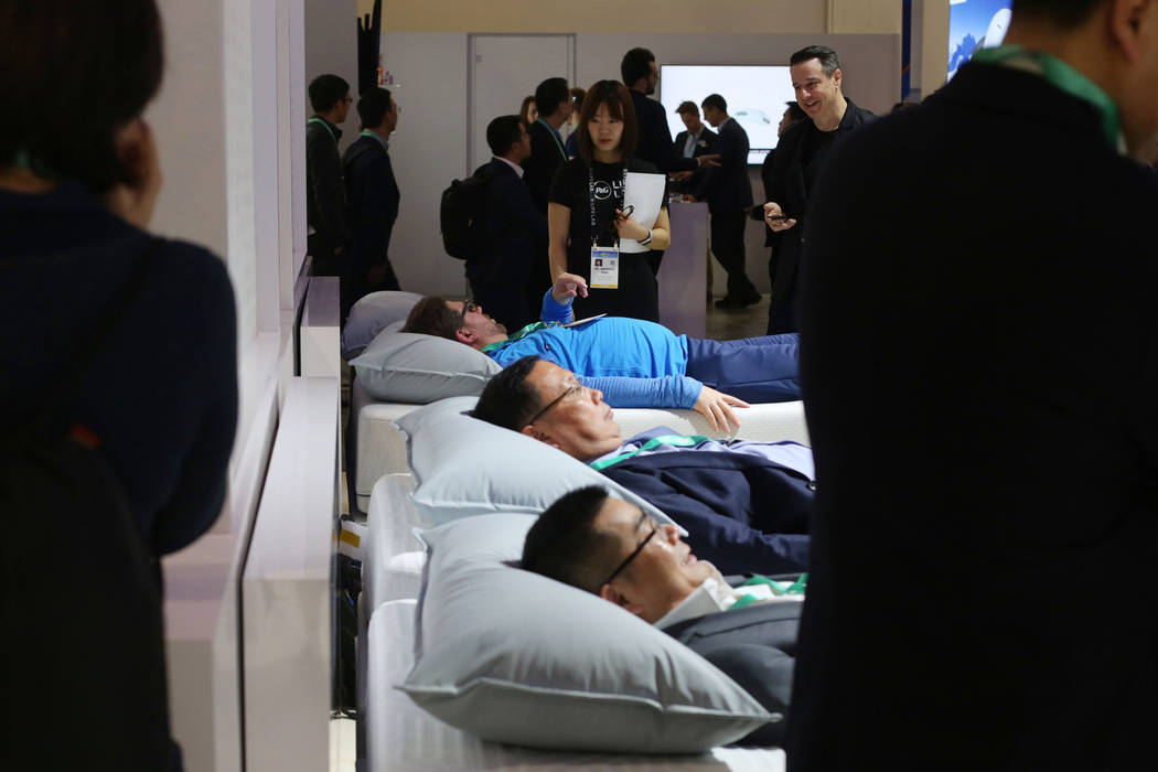 Individuals lay on the Sleep Number 360 Smart Bed during the first morning of CES 2020 at the S ...