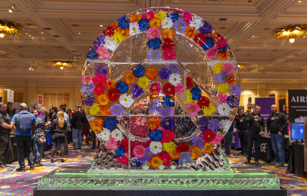 A peace sign frozen with flowers inside greets attendees during Pepcom's Digital Experience! CE ...
