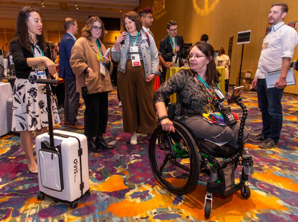 Kimberley Barreda is followed by an Ovis AI-powered suitcase during Pepcom's Digital Experience ...