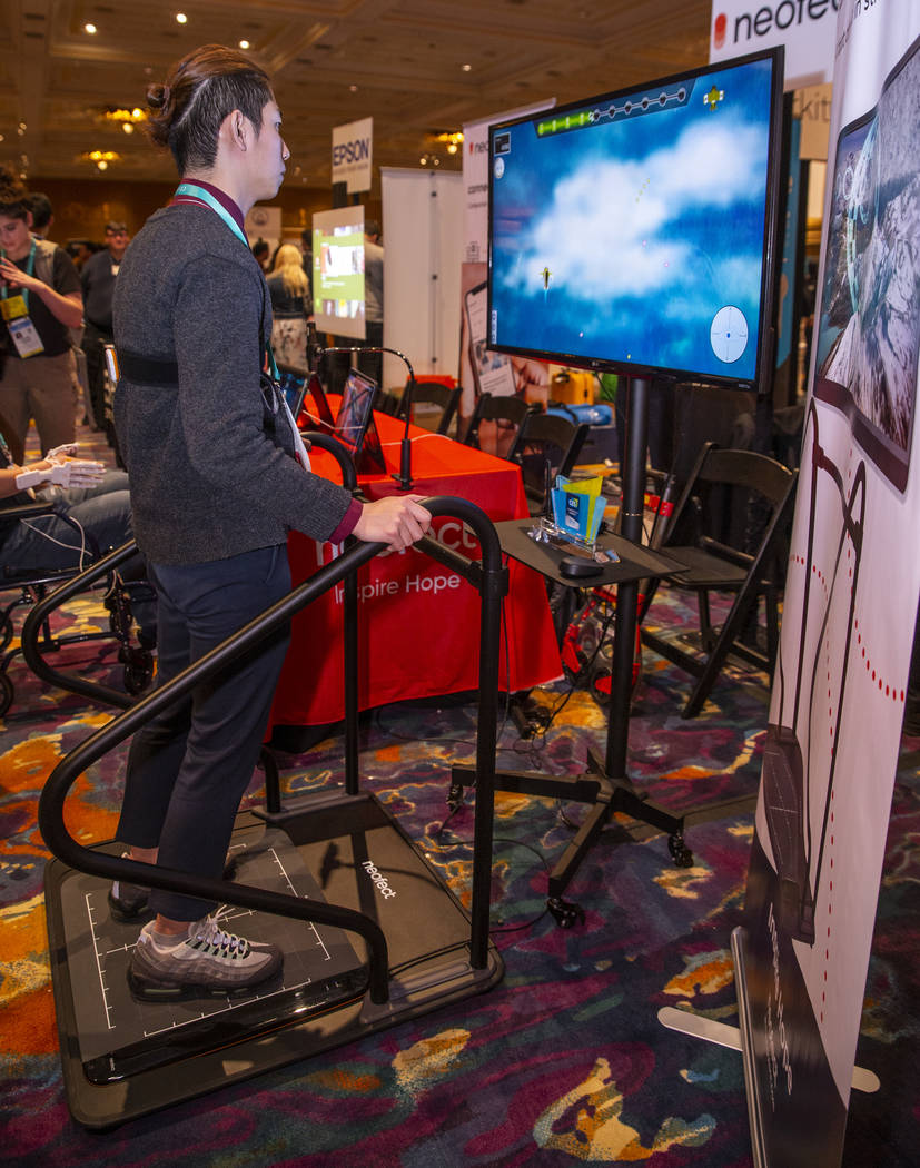 Byunggeol Park demonstrates the Neofect Smart Balance machine for stroke rehabilitation during ...