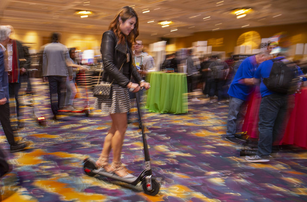 Sherry Wu demonstrates a new Unagi electric scooter during Pepcom's Digital Experience! CES at ...