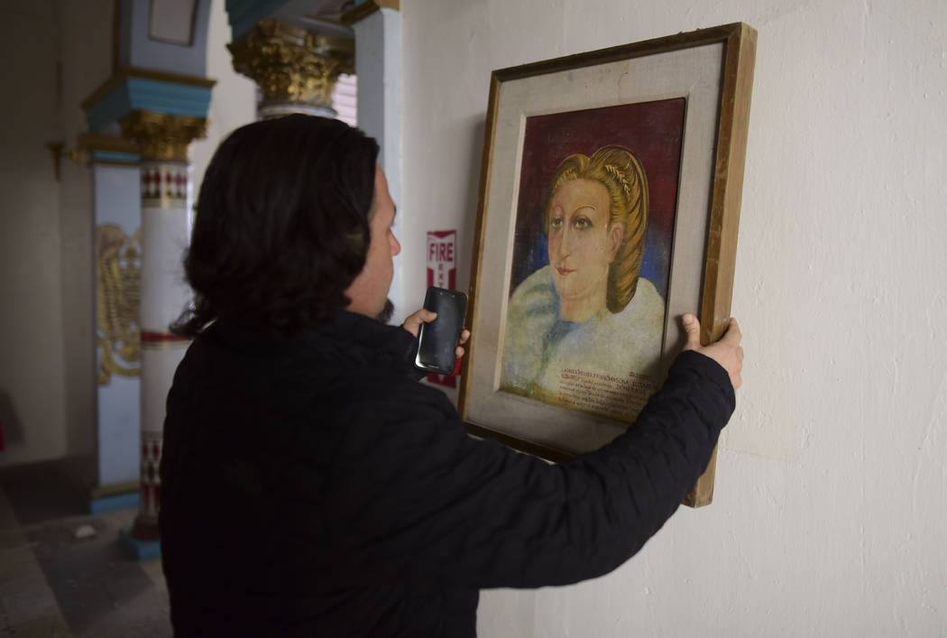 Jose Graziani removes a painting after an earthquake struck Puerto Rico before dawn, in Ponce, ...