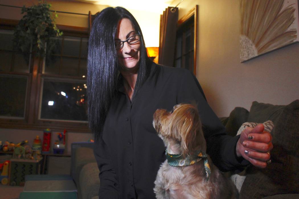 In this Nov. 5, 2019 photo, Amy Carter looks at her dog Bentley at her home in St. Francis, Wis ...