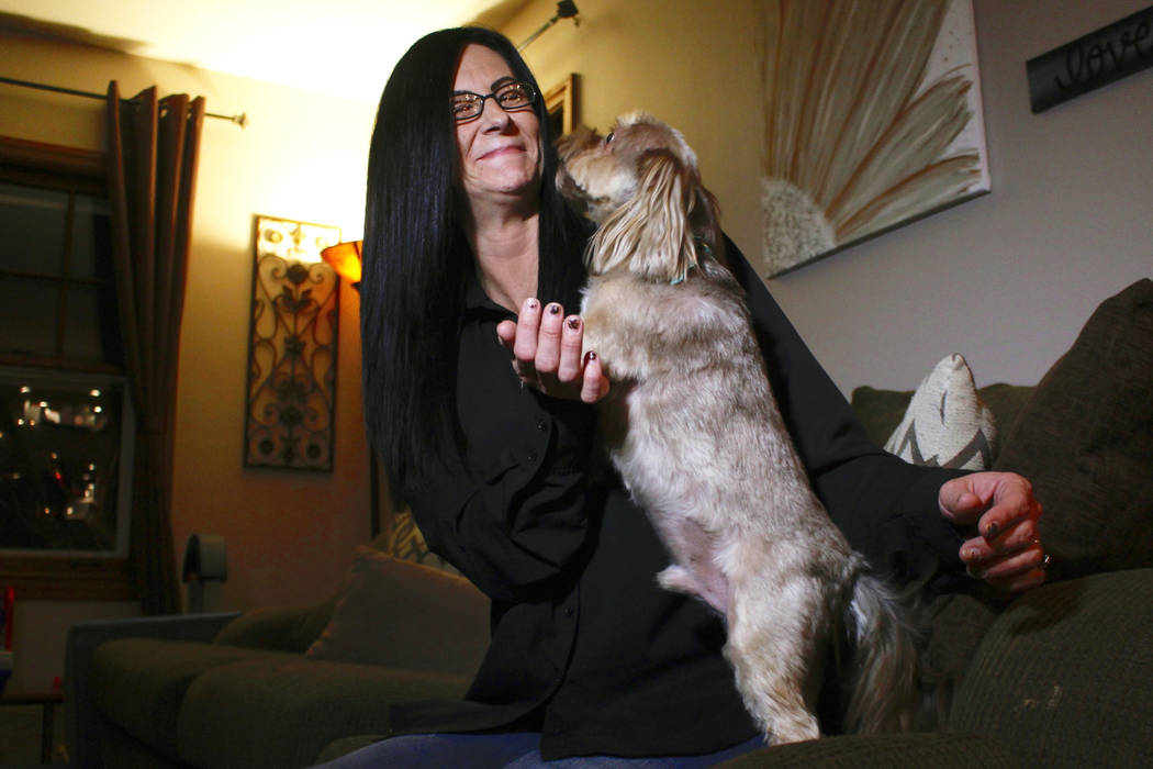 In this Nov. 5, 2019 photo, Amy Carter lets her dog Bentley lick her face at her home in St. Fr ...