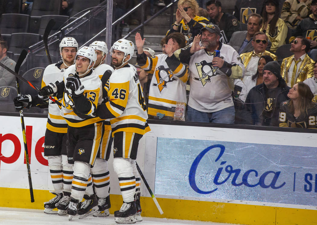 Pittsburgh Penguins' Brandon Tanev (13) is congratulated by teammates after his goal against th ...