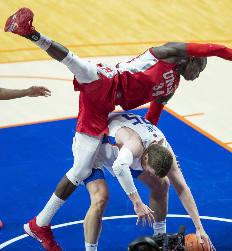 UNLV forward Cheikh Mbacke Diong falls on top of Boise State center Robin Jorch during the seco ...