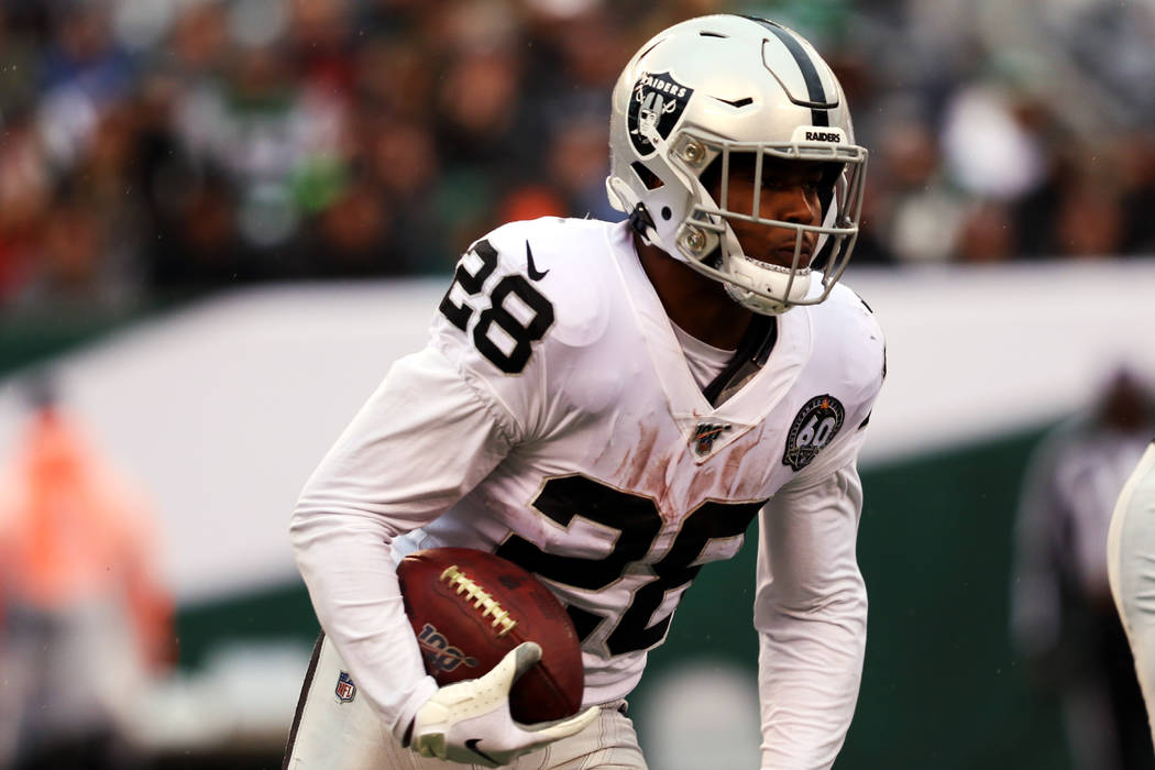 Oakland Raiders running back Josh Jacobs (28) runs with the football during the first half of a ...