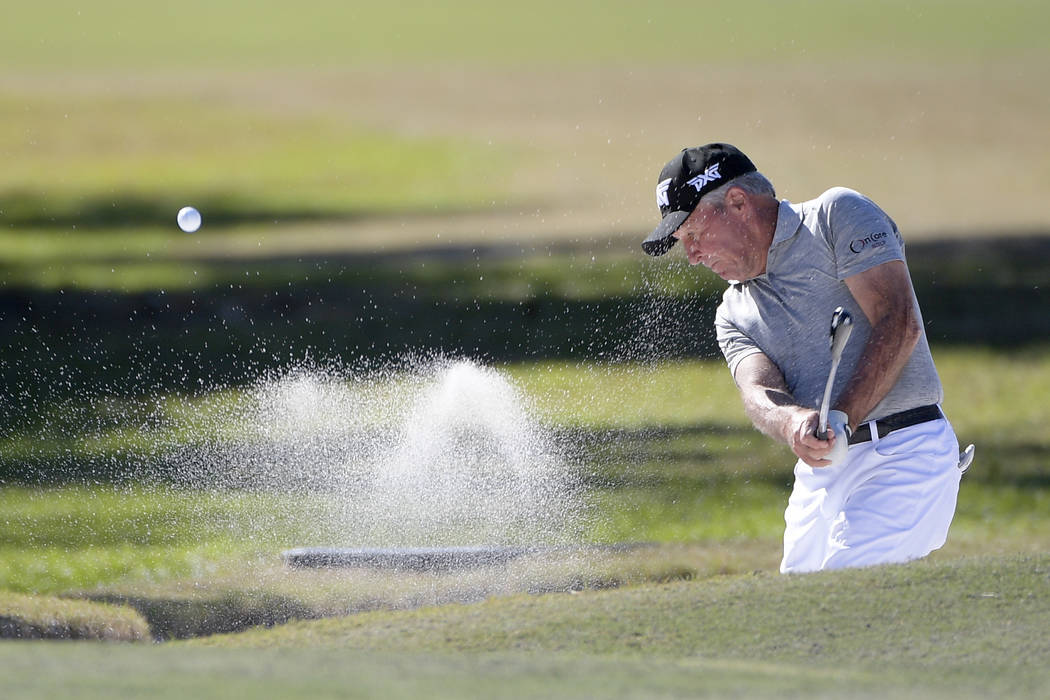 Gary Player hits out of a bunker onto the seventh green during the first round of the Father So ...