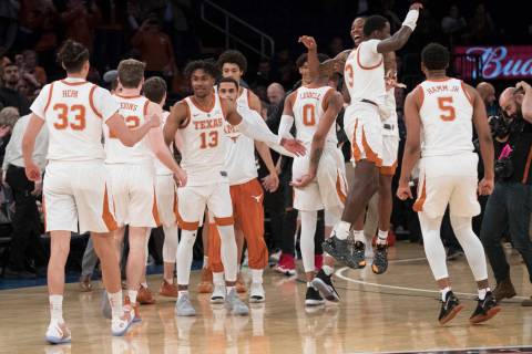 Texas players react after defeating Lipscomb in the championship basketball game of the Nationa ...