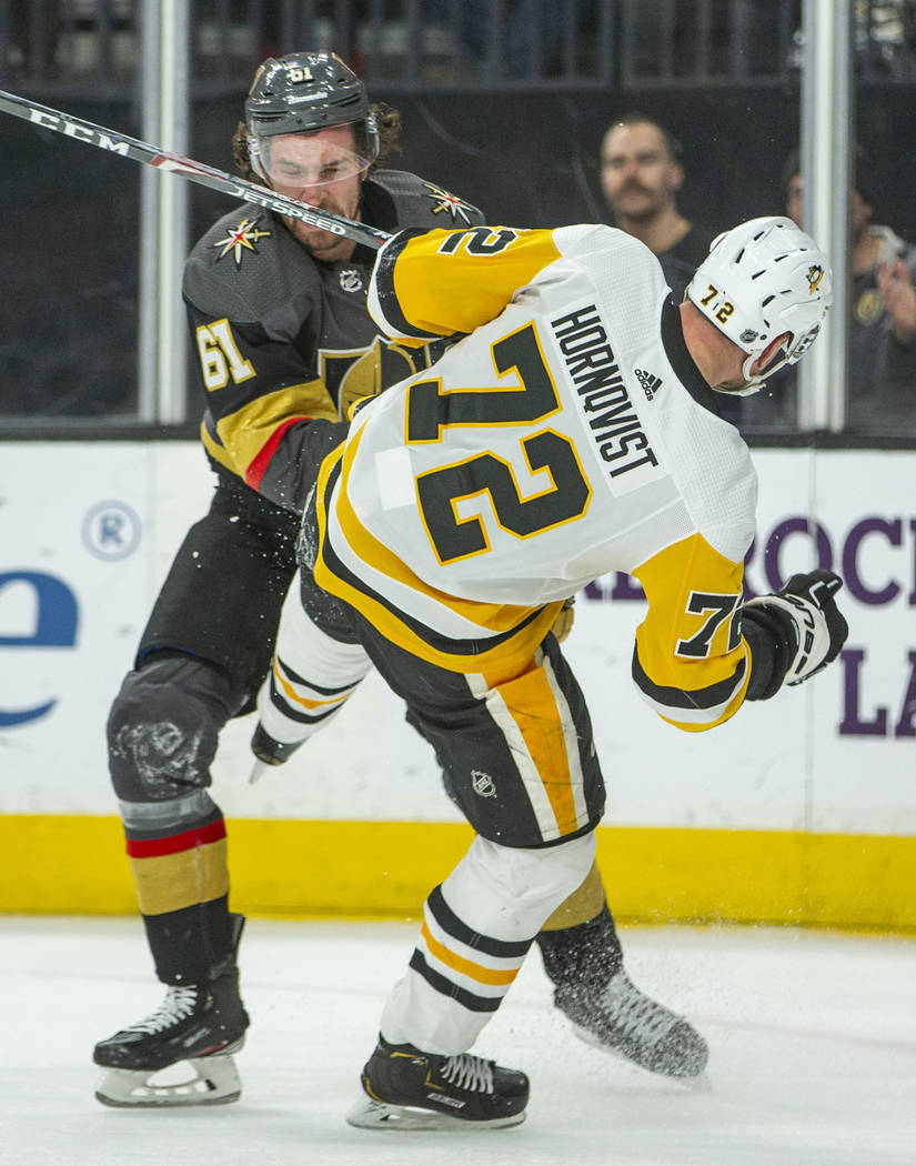 Vegas Golden Knights' Mark Stone (61) knocks down Pittsburgh Penguins' Patric Hornqvist (72) du ...