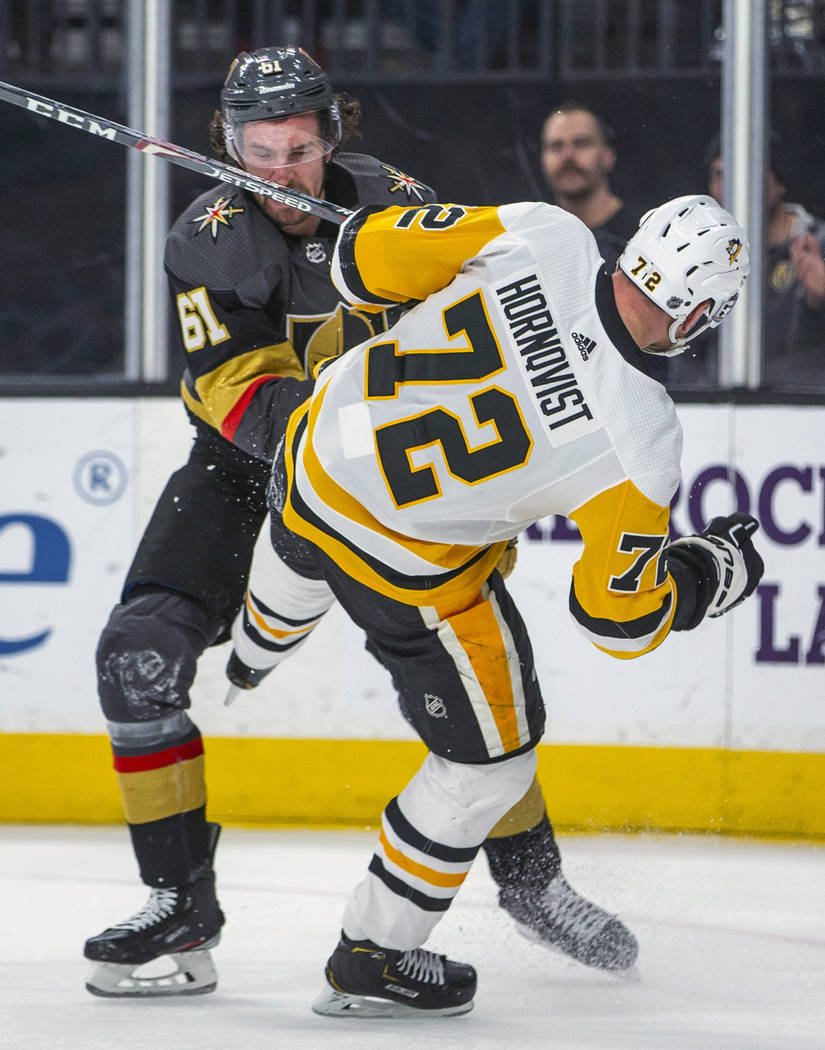 Vegas Golden Knights' Mark Stone (61) knocks down Pittsburgh Penguins' Patric Hornqvist (72) du ...