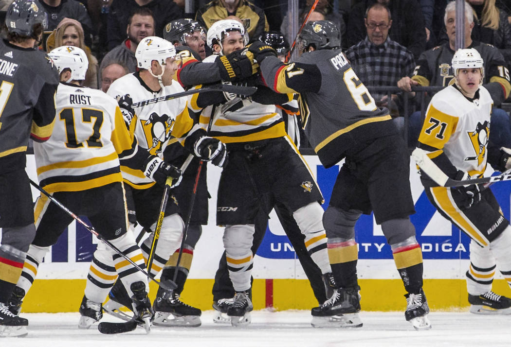 Pittsburgh Penguins and Vegas Golden Knights fight during the second period of an NHL hockey ga ...