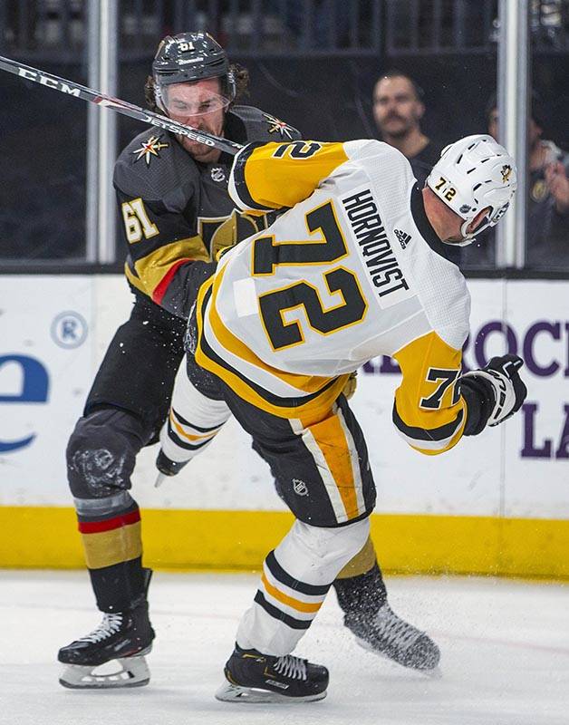 Vegas Golden Knights' Mark Stone (61) knocks down Pittsburgh Penguins' Patric Hornqvist (72) du ...