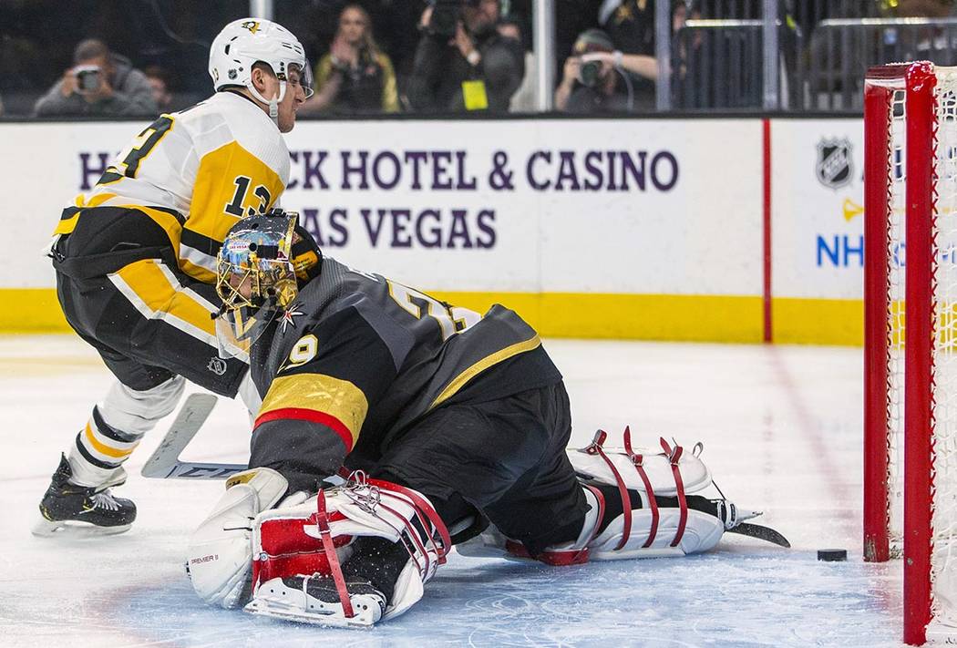 Pittsburgh Penguins' Brandon Tanev (13) scores on Vegas Golden Knights goaltender Marc-Andre Fl ...