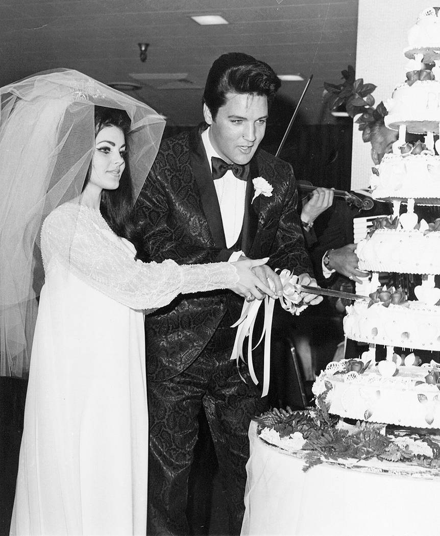 This May 1967 file photo of Elvis Presley and his new bride Priscilla cutting the cake at their ...