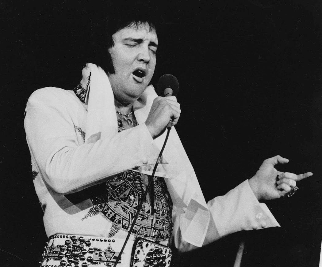 Elvis Presley performs during a concert in Providence, R.I. on May 23, 1977, three months befor ...