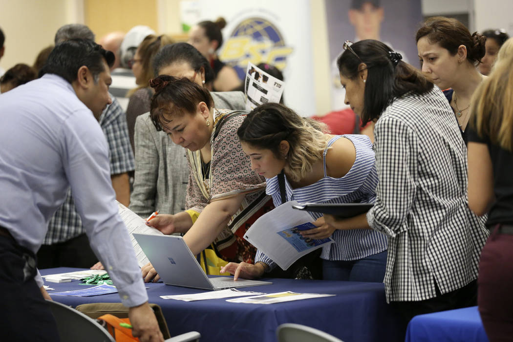 In a Sept. 18, 2019, file photo, job applicants looks at jobs available at Florida Internationa ...