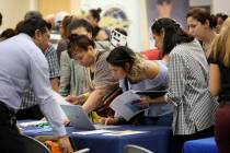 In a Sept. 18, 2019, file photo, job applicants looks at jobs available at Florida Internationa ...