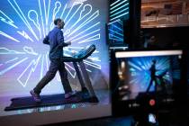 Hernan La Rosa of Argentina tries out Asics tennis shoes in their interactive exhibit on Wednes ...