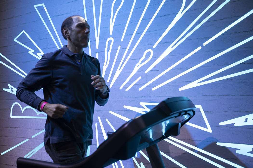 Hernan La Rosa of Argentina tries out Asics tennis shoes in their interactive exhibit on Wednes ...