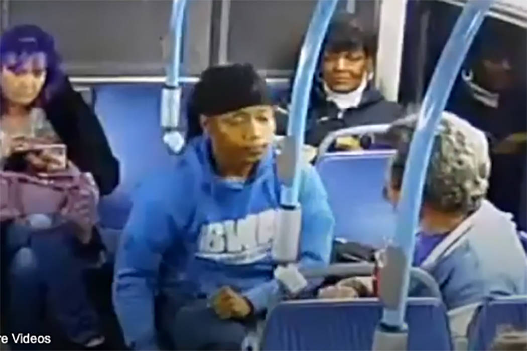 A screengrab from video shows a man, center, who punched an older man in the face on a Regional ...