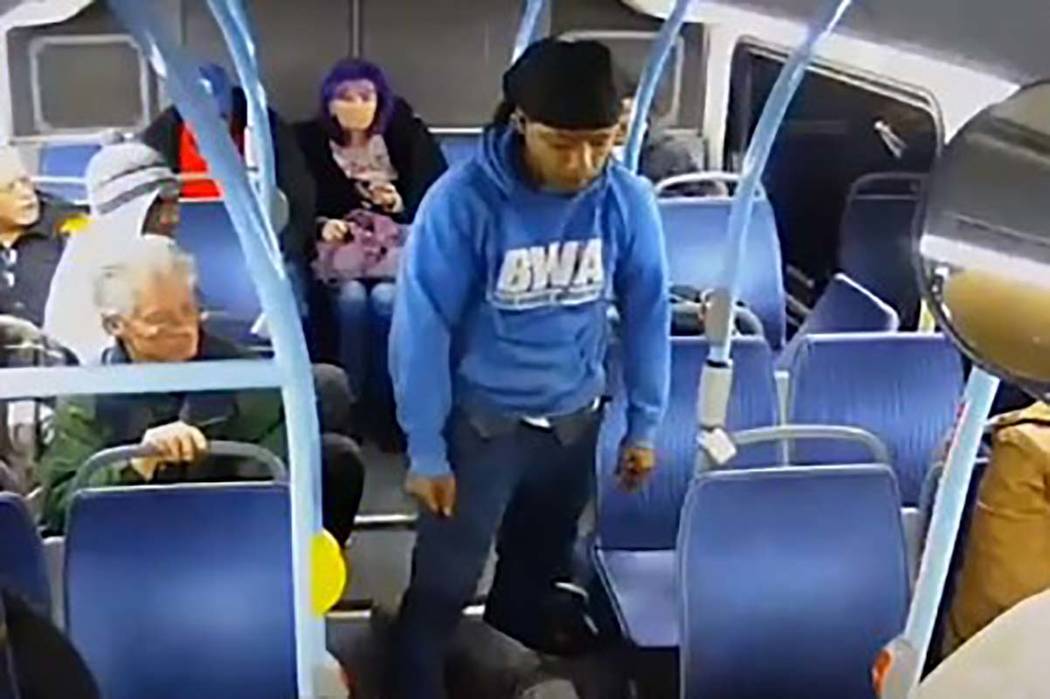 A screengrab from video shows a man, center, who punched an older man in the face on a Regional ...