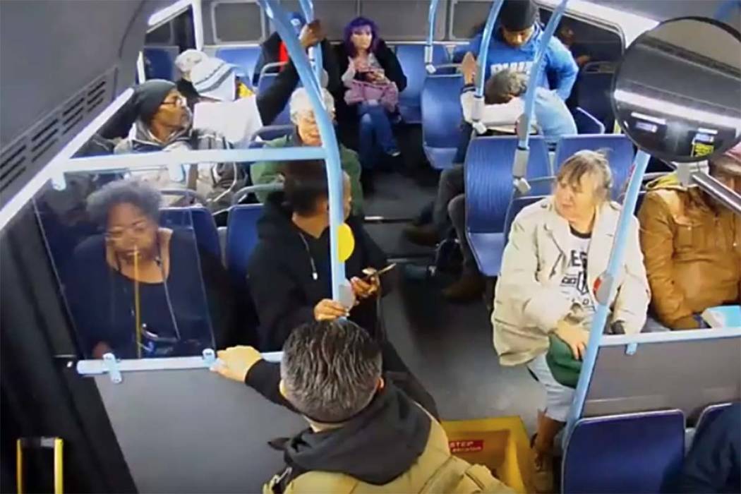 In a screengrab from video, a younger man punches an older man in the face on a Regional Transp ...