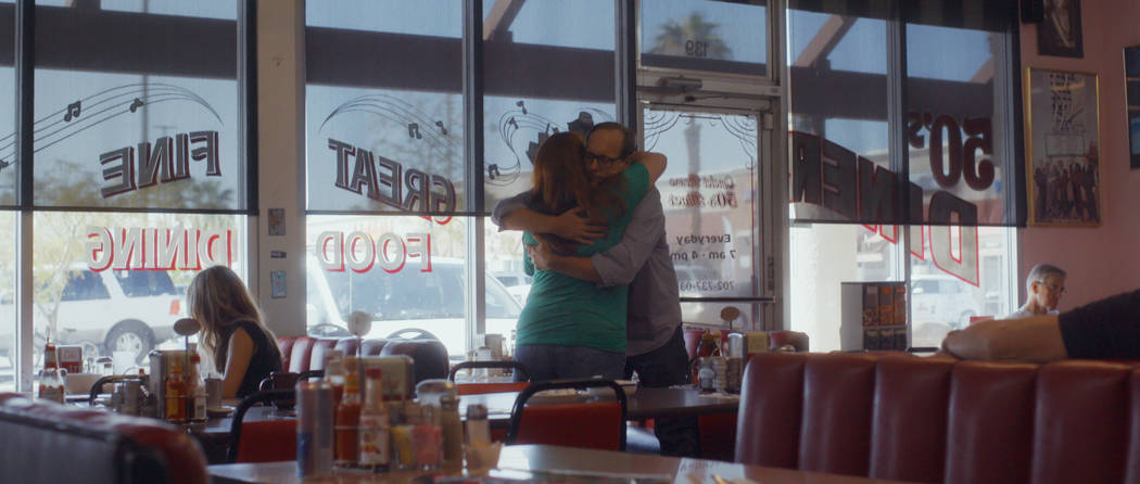 Deanna and John Green share a hug at a diner. (NETFLIX)