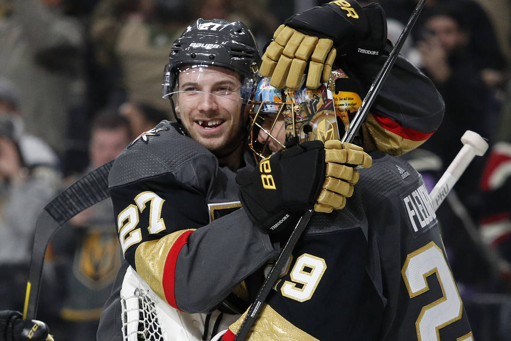 Vegas Golden Knights defenseman Shea Theodore (27) embraces goaltender Marc-Andre Fleury (29) a ...