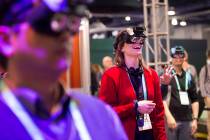 Alyson Lemmer, of Chicago, tries out Realmax virtual reality at CES at the Las Vegas Convention ...