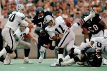 In this Nov. 5, 1984, file photo, Chicago Bears defensive end Richard Dent (95) brings down Los ...