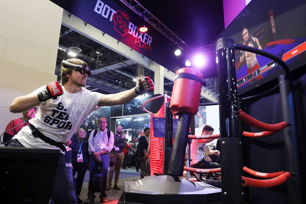 Sergii Dolgyi shows attendees how BotBoxer's workout program mixes virtual reality with a physi ...