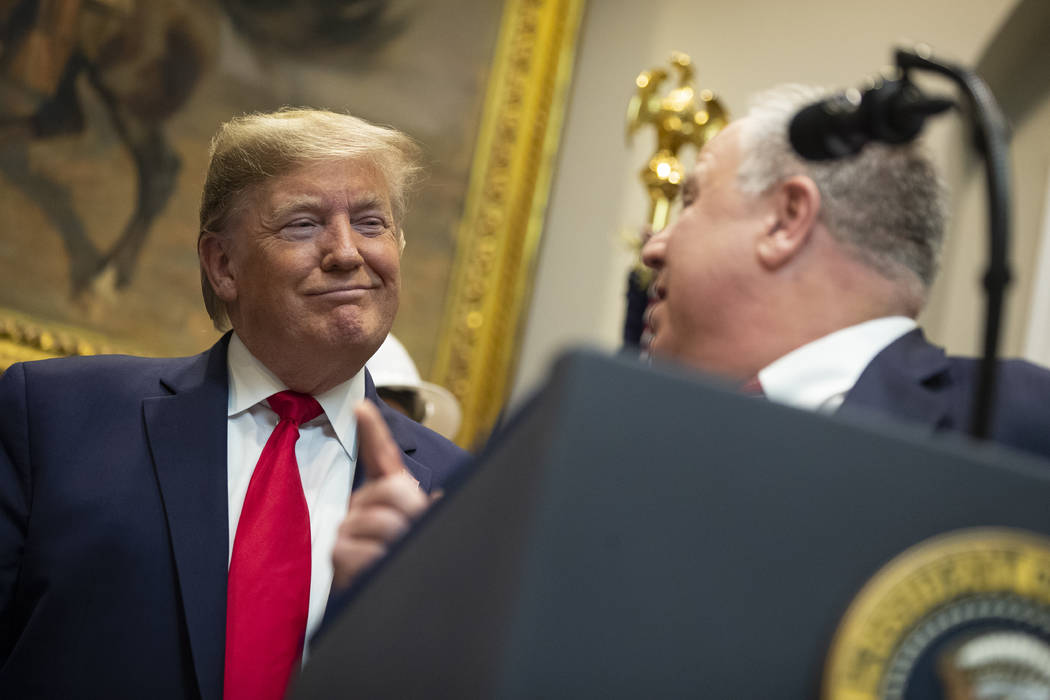 President Donald Trump listens as Secretary of the Interior David Bernhardt speaks on proposed ...