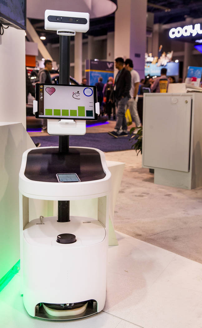 The PECOLA is a companion robot incorporating ambient intelligence for the elderly on display i ...