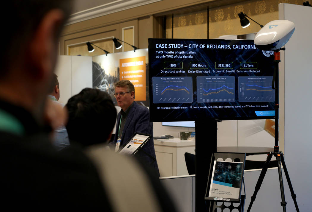 A CES attendee observes the first AI-powered traffic signal platform, NoTraffic, during CES at ...