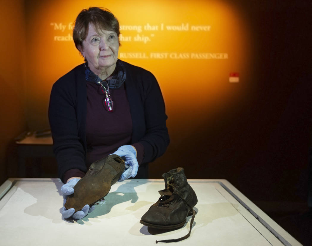 Alexandra Klingelhofer, executive director for collections, holds a pair of dress boots worn by ...