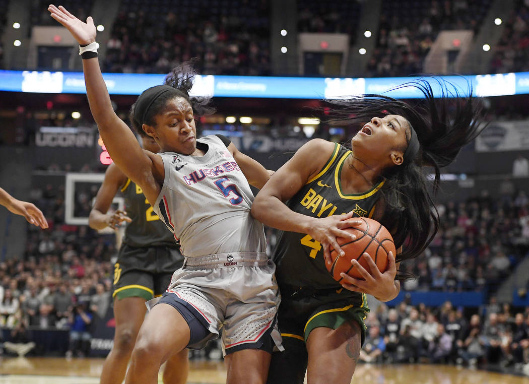 Connecticut's Crystal Dangerfield, left, fouls Baylor's Te'a Cooper during the first half of an ...
