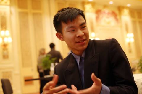 Stanley Liu, 16, winner of a Young Innovators to Watch Scholarship Program award, speaks with a ...