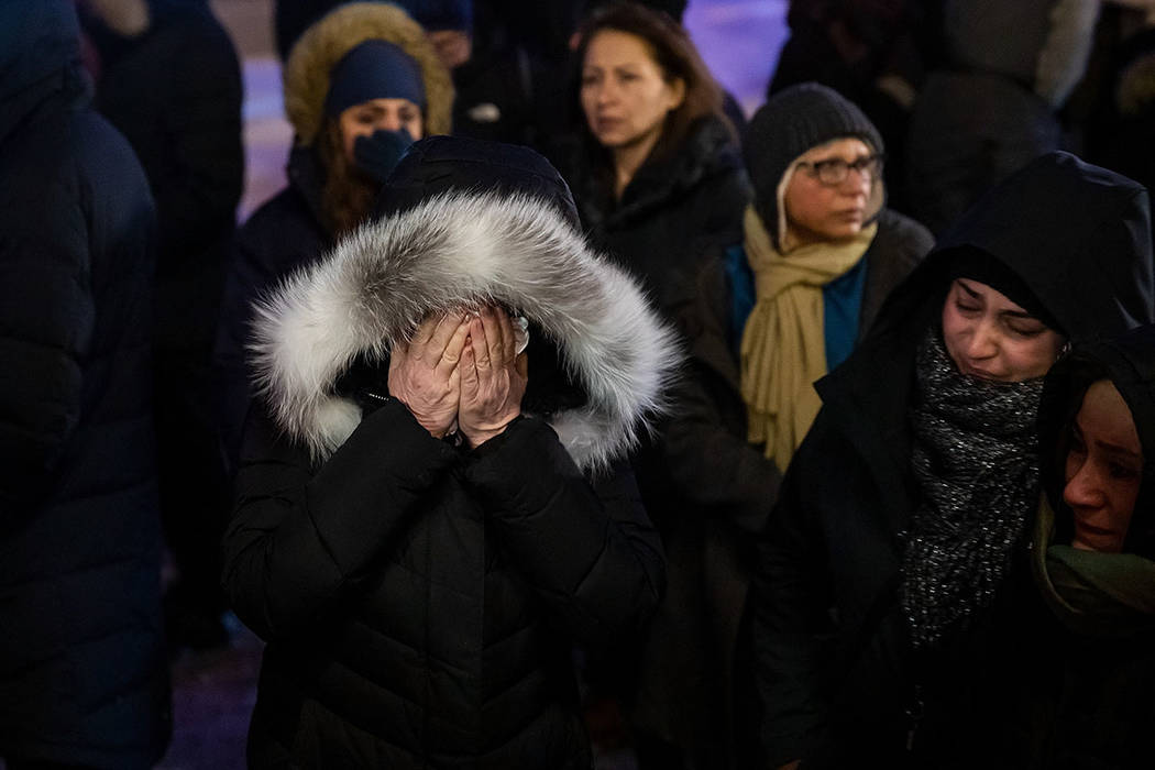 A woman mourns outside the Alberta Legislature Building in Edmonton, Alberta, Wednesday, Jan. 8 ...
