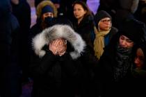 A woman mourns outside the Alberta Legislature Building in Edmonton, Alberta, Wednesday, Jan. 8 ...
