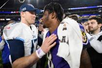 Tennessee Titans quarterback Ryan Tannehill, left, speaks with Baltimore Ravens quarterback Lam ...