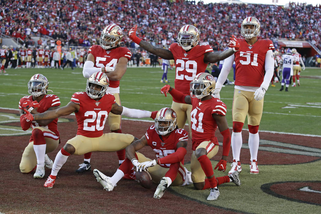 San Francisco 49ers players celebrate as a group after cornerback Richard Sherman (25), bottom ...