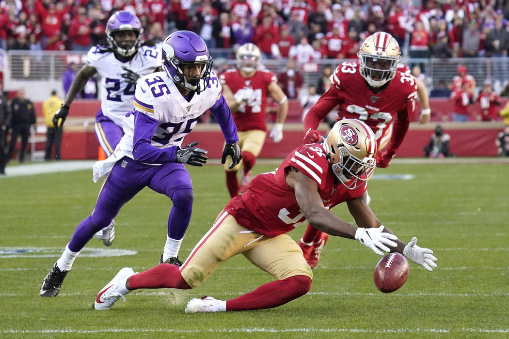 San Francisco 49ers' Raheem Mostert, lower right, recovers the ball after Minnesota Vikings' Ma ...