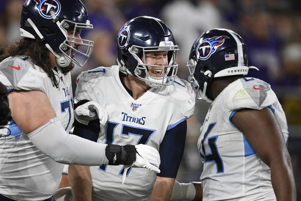 Tennessee Titans quarterback Ryan Tannehill (17) celebrates with teammates after a touchdown ag ...
