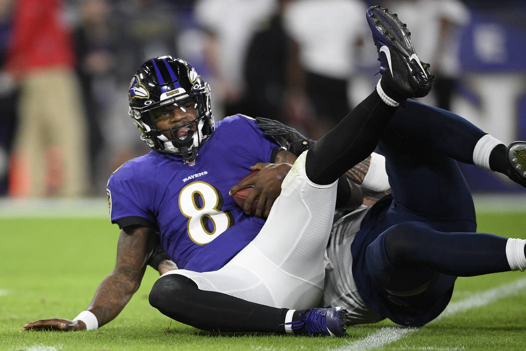 Baltimore Ravens quarterback Lamar Jackson (8) is sacked by Tennessee Titans outside linebacker ...