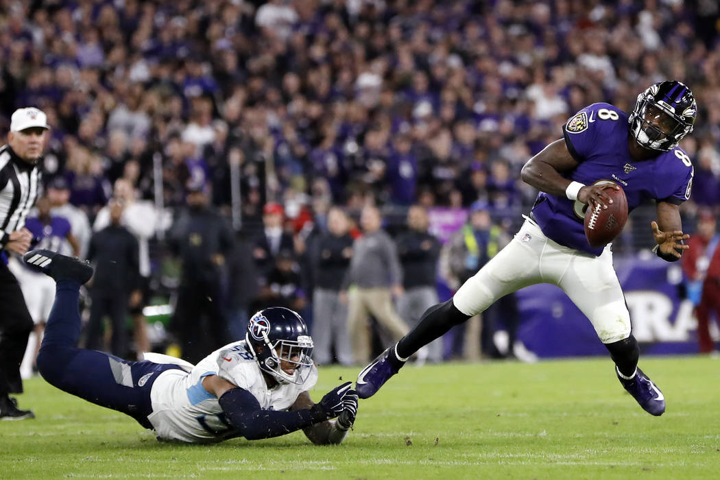 Baltimore Ravens quarterback Lamar Jackson (8) slips away from Tennessee Titans linebacker Haro ...